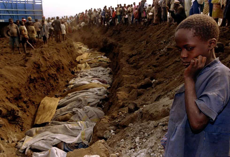 20-July-1994-A-Rwandan-refugee-girl-stands-next-to-a-mass-grave-outside-Kigali-where-dozens-of...jpg